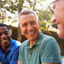 three men outside smiling