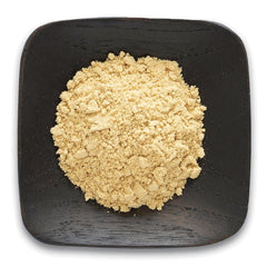 FNP040 | Pile of light beige powder on a square dark wooden plate, top-down product shot