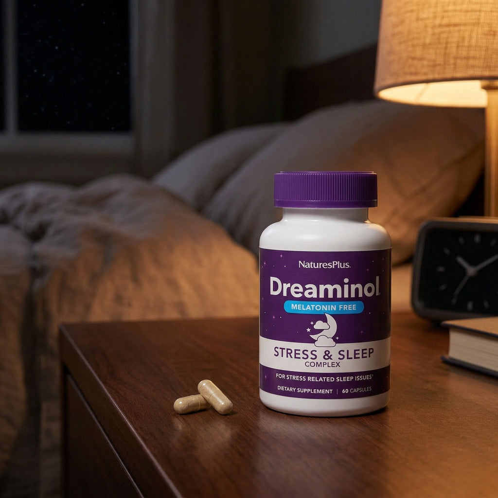 NTP354 | NaturesPlus Dreaminol stress and sleep supplement bottle with capsules on a bedside table - Thumbnail