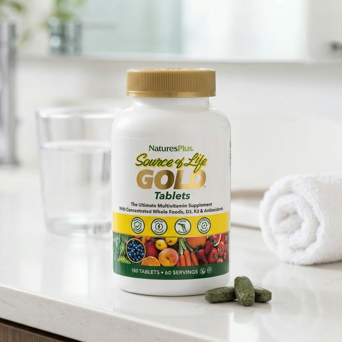 NTP360 | NaturesPlus Source of Life Gold Tablets bottle on a bathroom counter with tablets and towel
