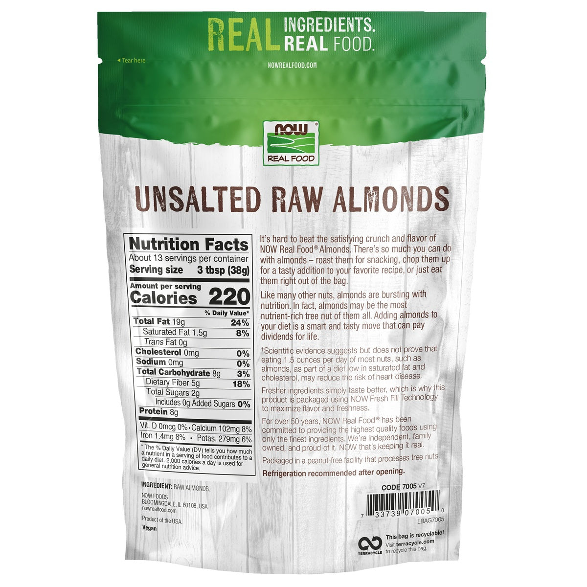 NWF927 | raw almonds spilling from open brown bag on wooden surface
