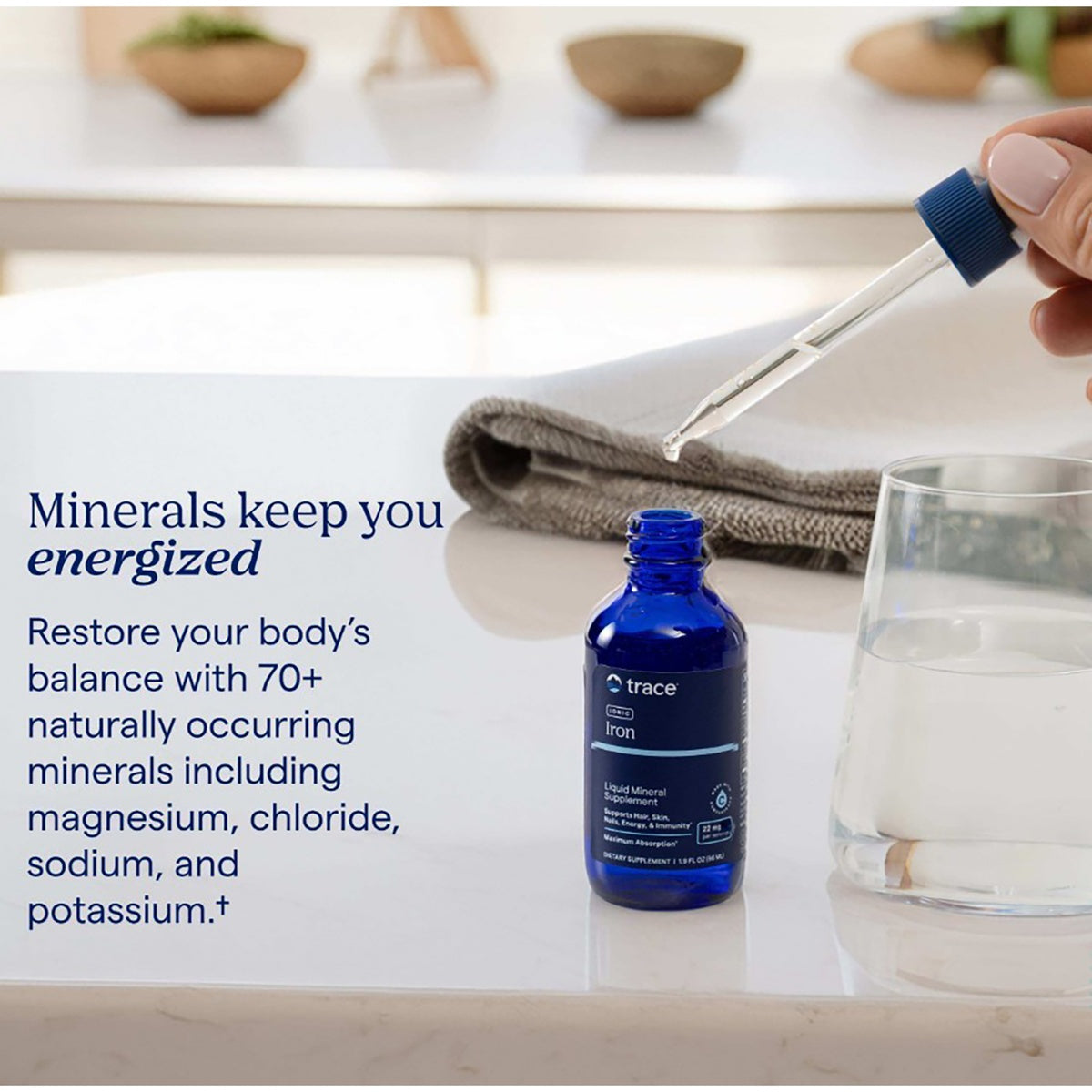 TM035 | Trace Ionic Iron liquid mineral supplement with minerals and dropper beside a glass of water and towel