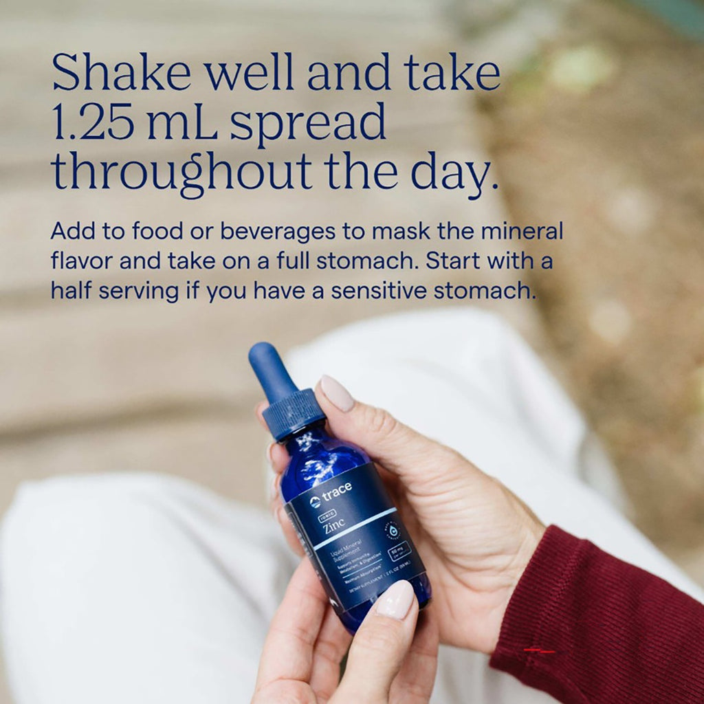 TM027 | Hand holding Trace Zinc liquid mineral supplement with usage instructions - Thumbnail
