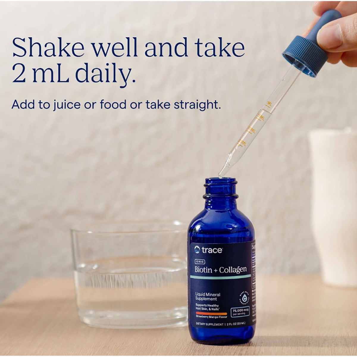 TM147 | Trace Ionic Biotin + Collagen liquid supplement bottle on a table with the tagline Nourish from within