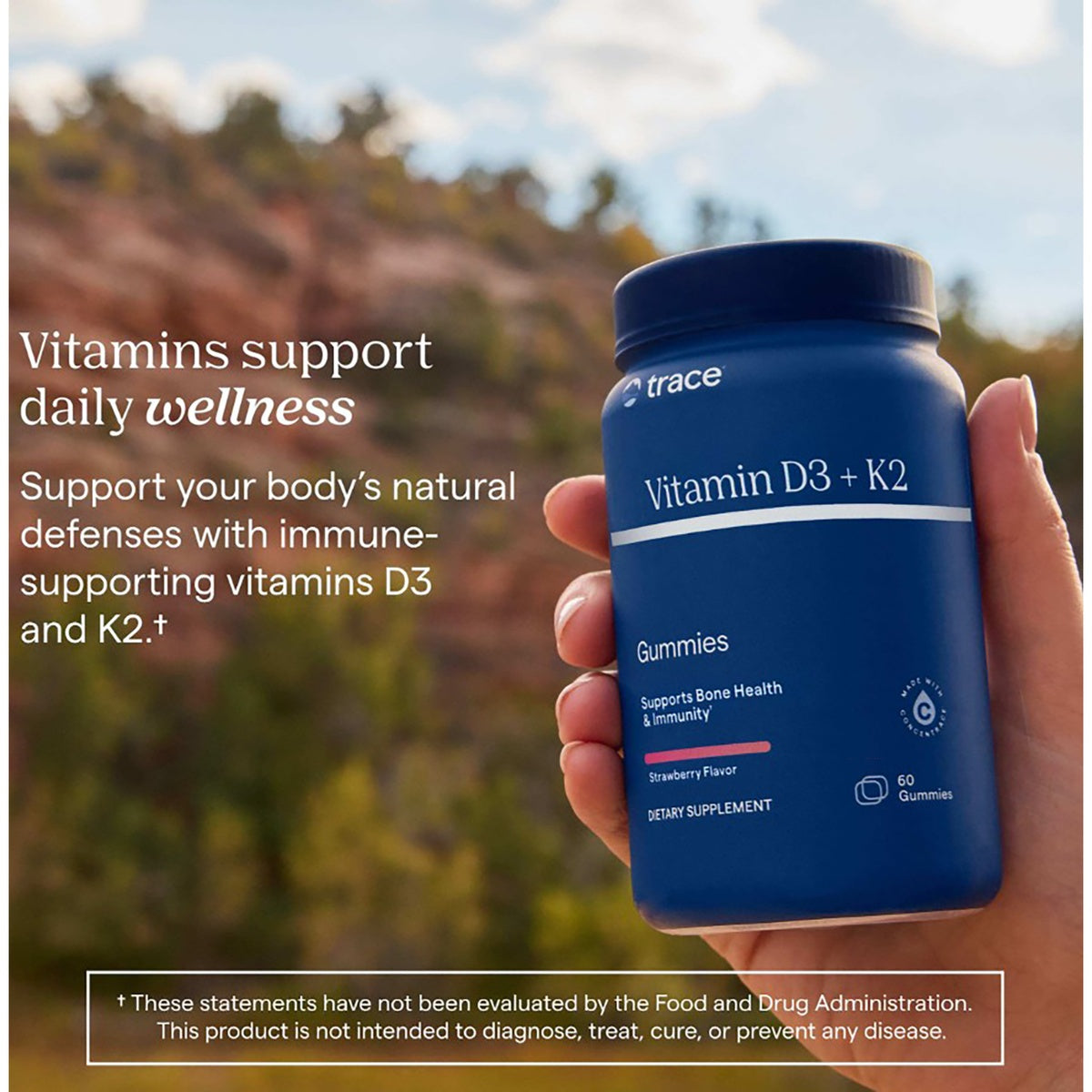 TM145 | Hand holding Trace Vitamin D3 + K2 gummies bottle with wellness text
