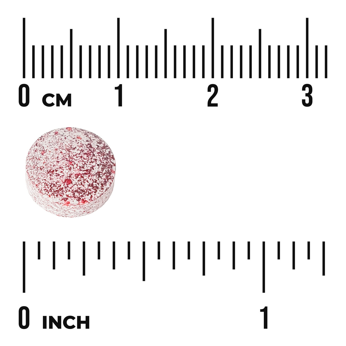 SWU783 | Round speckled red tablet next to centimeter and inch rulers, about 1 cm diameter