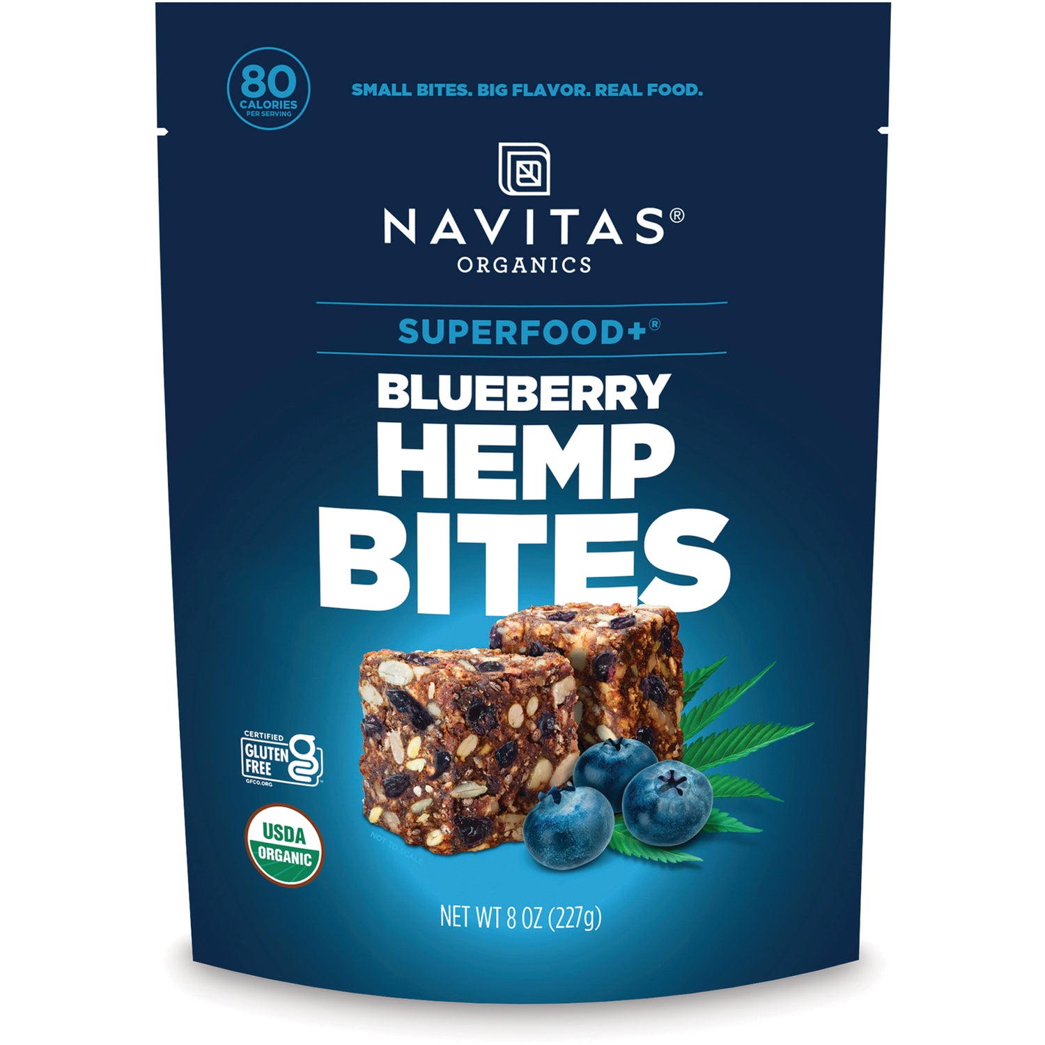 NAV042 | Navitas Organics Superfood+ Blueberry Hemp Bites front pouch with bowl of bite-size snacks and blueberries