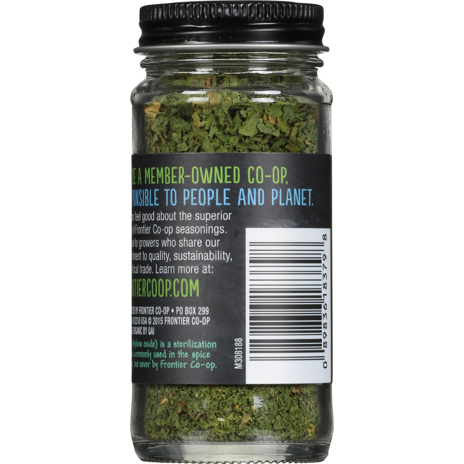 FNP010 | Back of clear spice jar showing label text, barcode, and dried green herbs inside