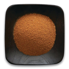 FNP076 | mound of fine reddish-brown powder in a black square bowl