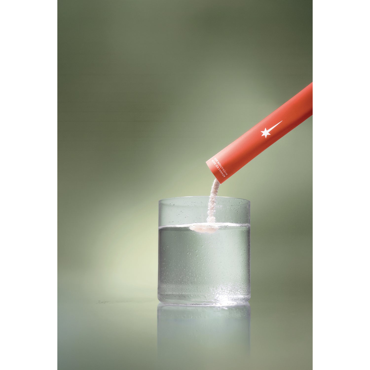 KTO003 | Red sachet pouring powder into a glass of water, with a star logo and Adventure Is All You Need text