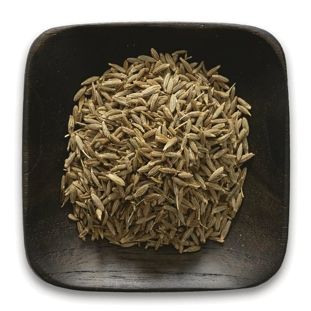 FNP078 | pile of light brown cumin seeds on a square dark wooden dish - Thumbnail