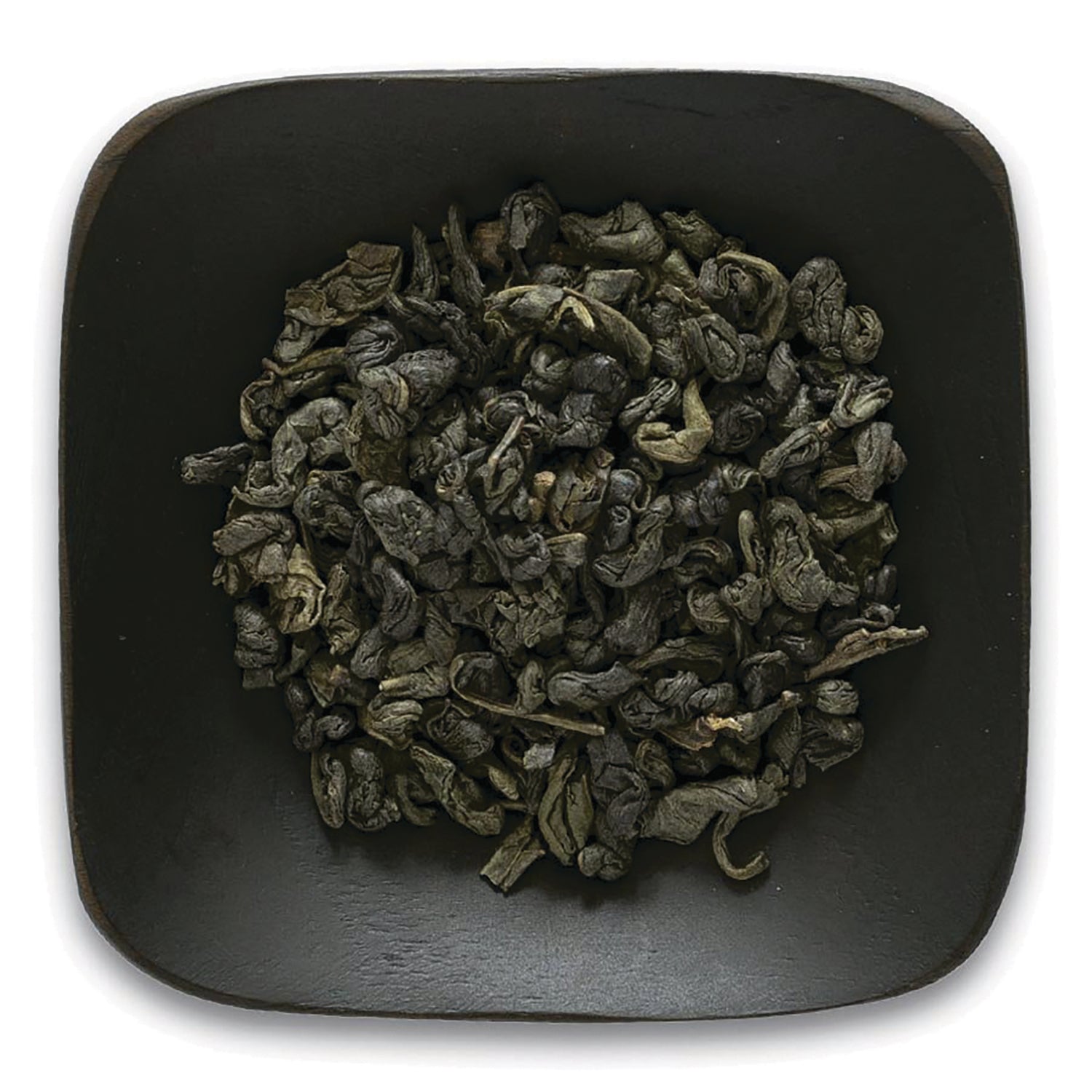 FNP082 | Top-down view of rolled green tea leaves in a dark square dish