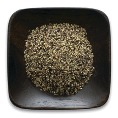 FNP061 | coarsely ground mixed peppercorns piled in a square dark wooden bowl