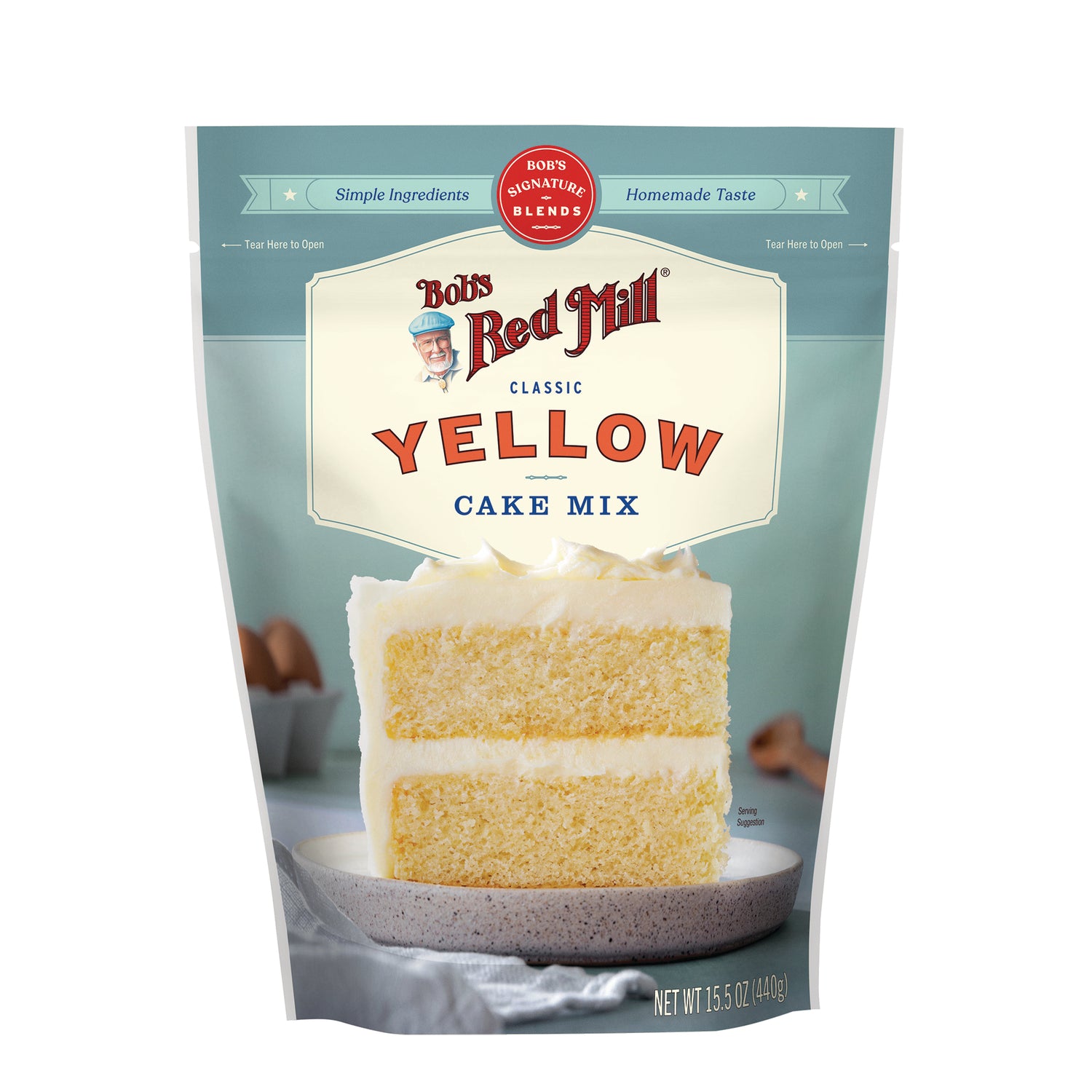 BOB481 | Bob's Red Mill Yellow Cake Mix pouch with two-layer frosted cake slice on a plate
