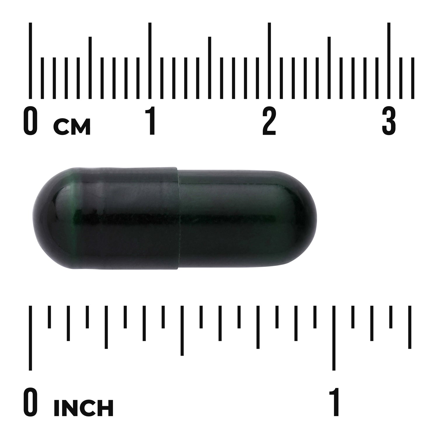 SWU542 | dark green capsule on centimeter and inch rulers showing approx 2 cm length, visible text "0 CM" and "0 INCH"