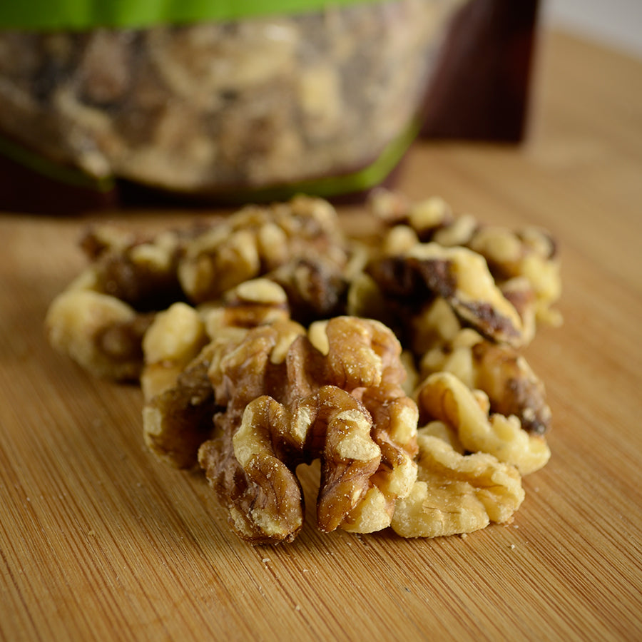 NWF1131 | close-up of shelled walnut halves on a wooden cutting board