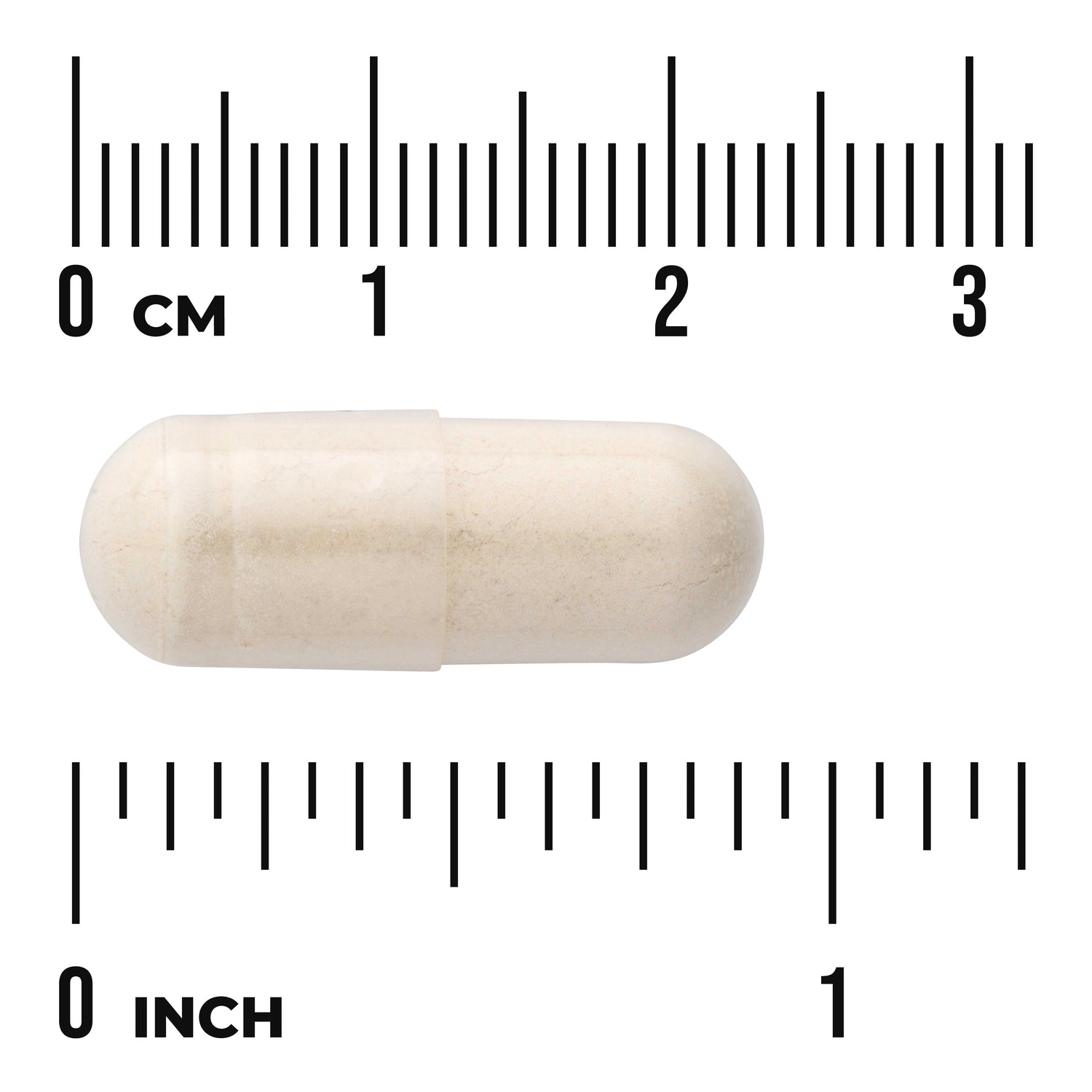 SWG07 | White capsule centered on ruler scales labeled 0 CM and 0 INCH to show size