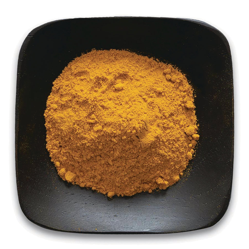 FNP364 | pile of turmeric-colored powder on a black square dish - Thumbnail