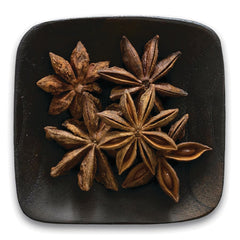 FNP382 | star anise pods arranged on a dark square plate