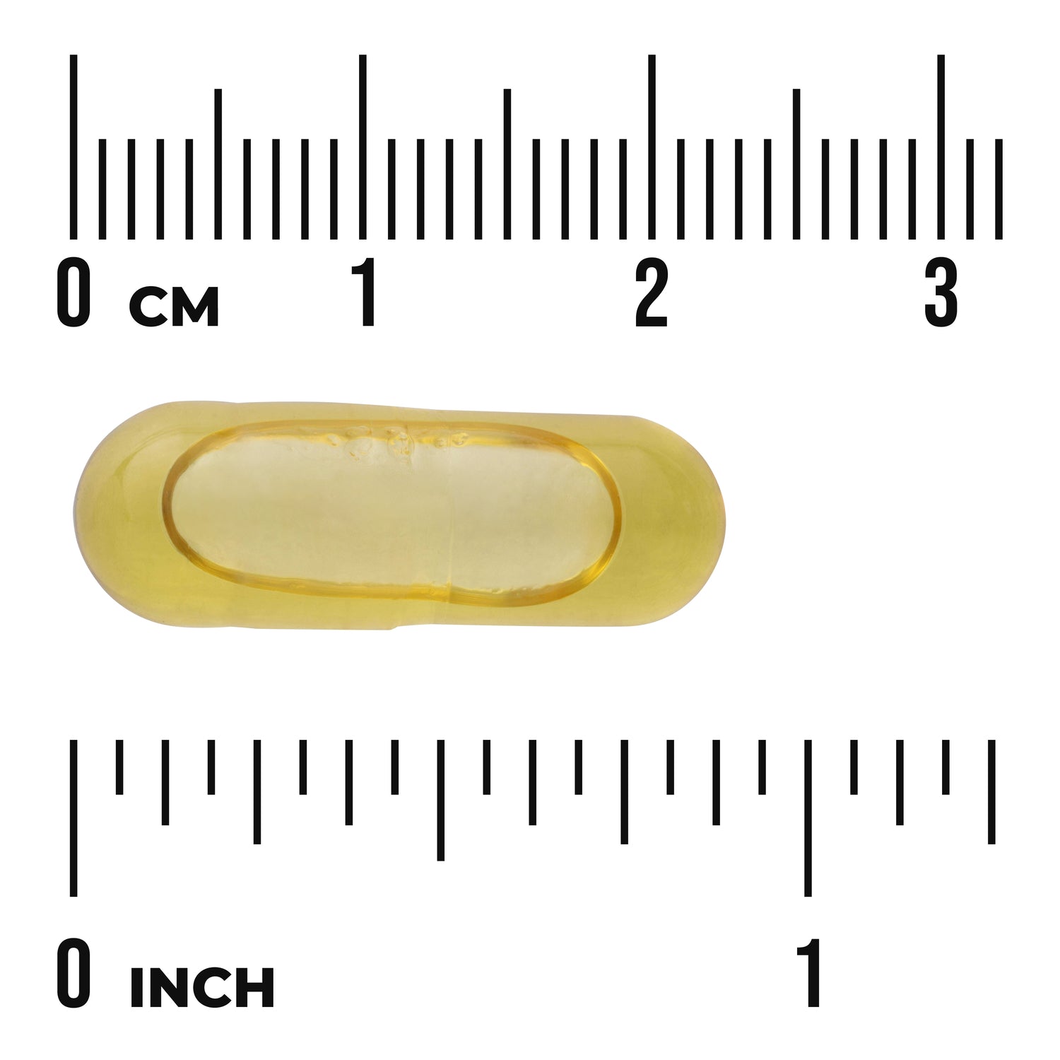 SWE063 | Yellow softgel capsule between centimeter and inch rulers showing 0 cm and 0 inch for size reference