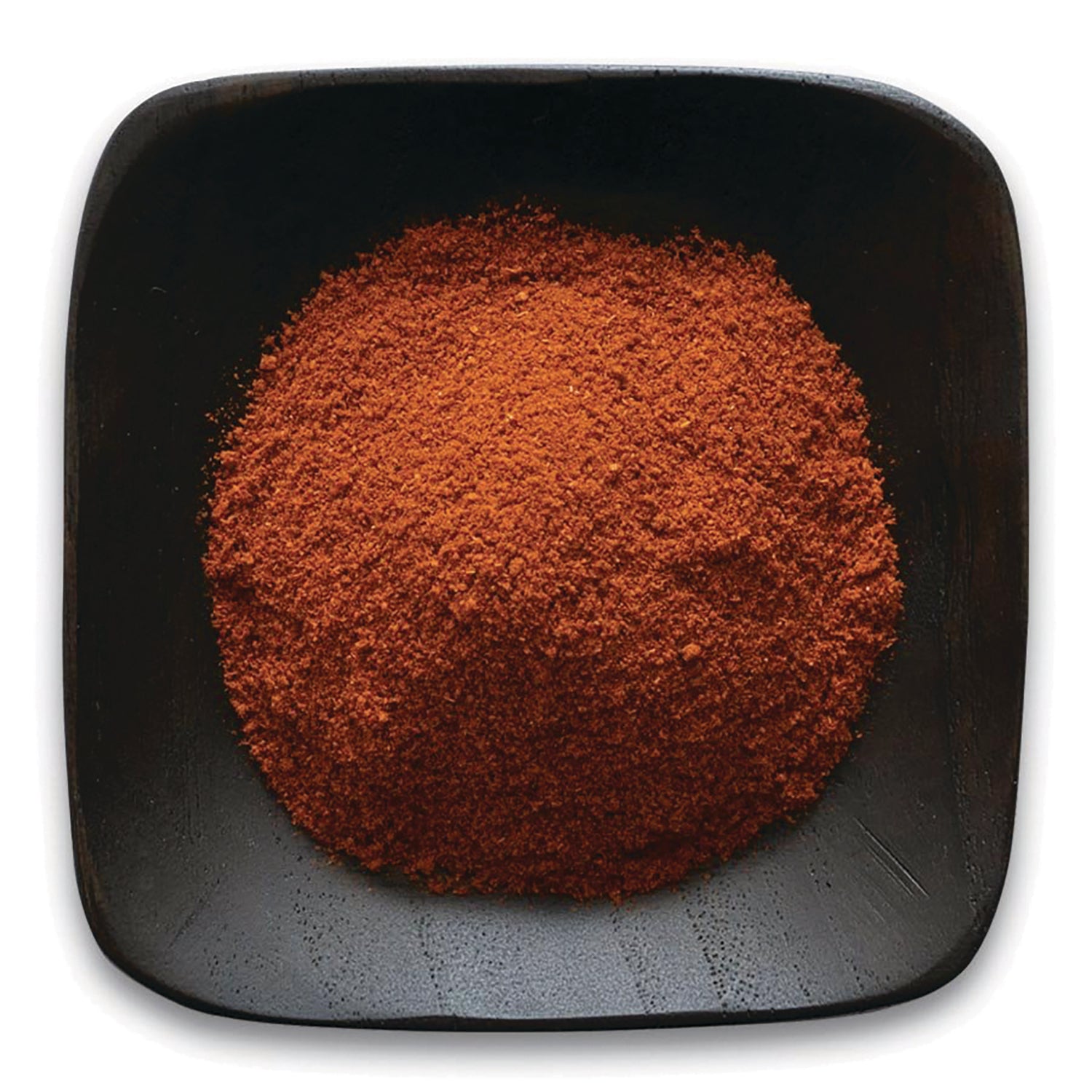 FNP054 | pile of red-brown ground spice in a square black dish