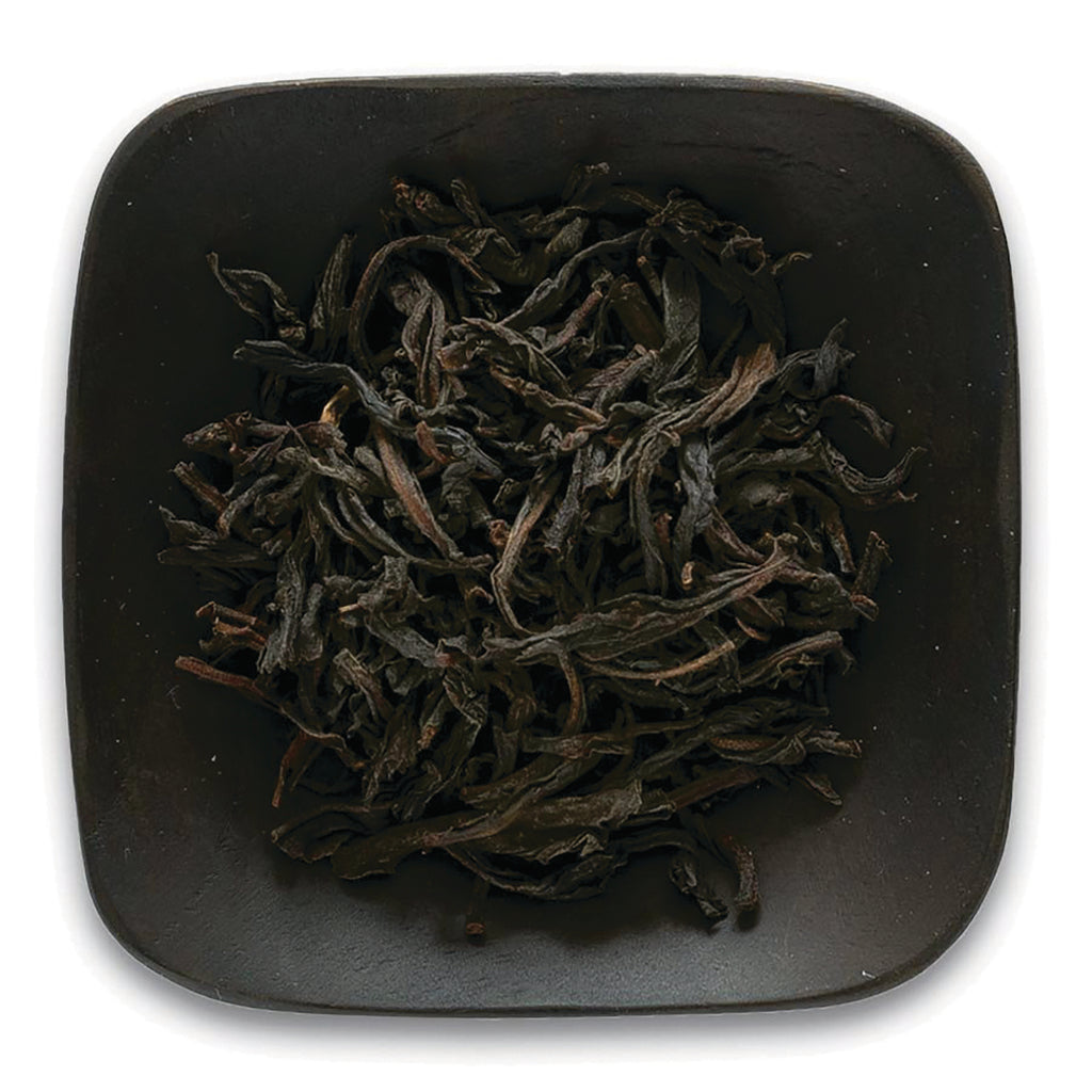 FNP085 | Top-down view of loose dried black tea leaves in a square dark ceramic dish - Thumbnail