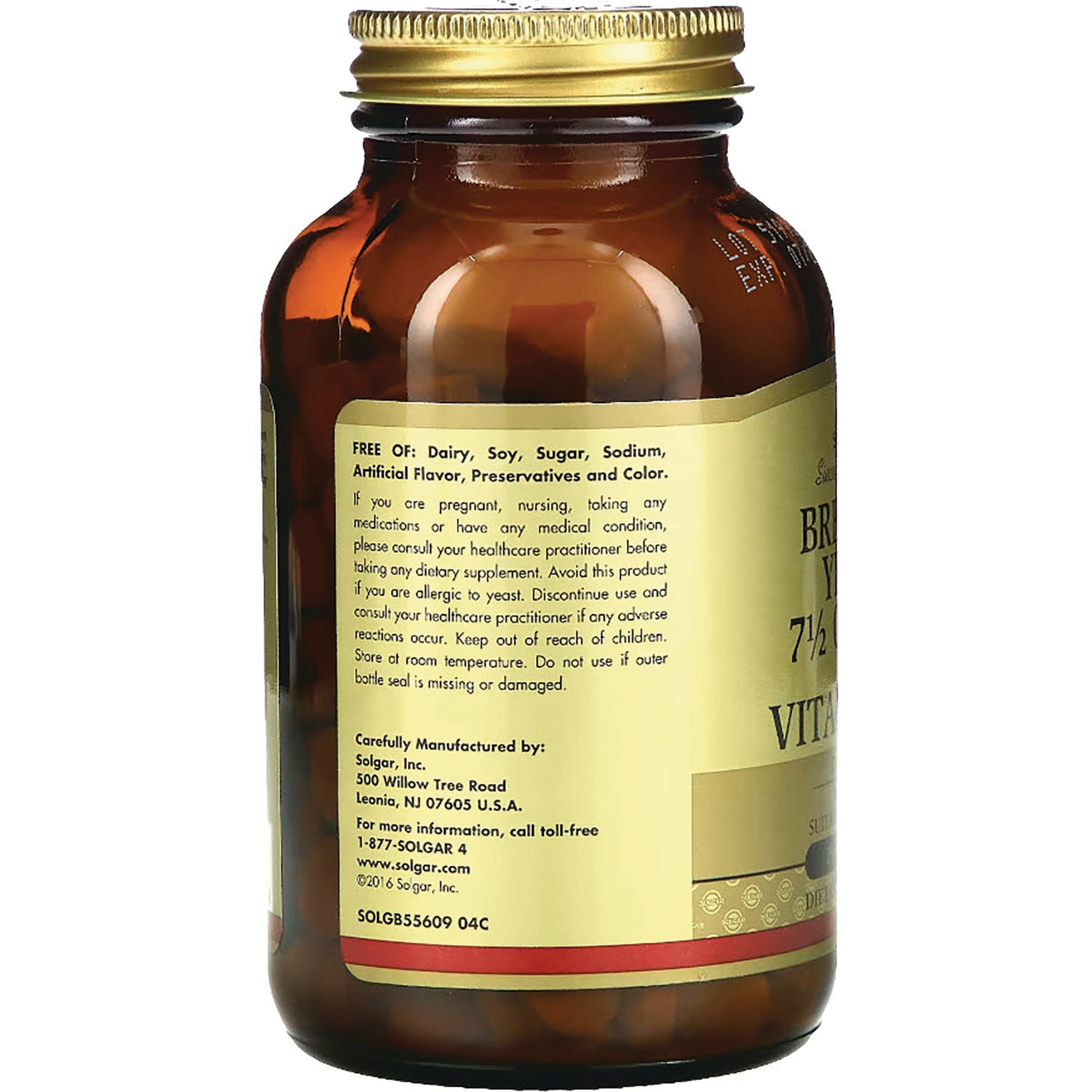 Amber supplement bottle back label showing ingredient list, warnings, and manufacturer contact details