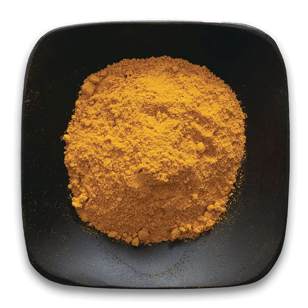 FNP361 | Bright orange turmeric powder piled on a black square plate - Thumbnail