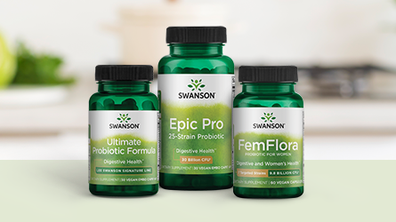 Swanson brand supplement bottles on a white surface with a blurred kitchen background