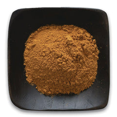 FNP022 | Heap of brown powder on square black dish, top-down view