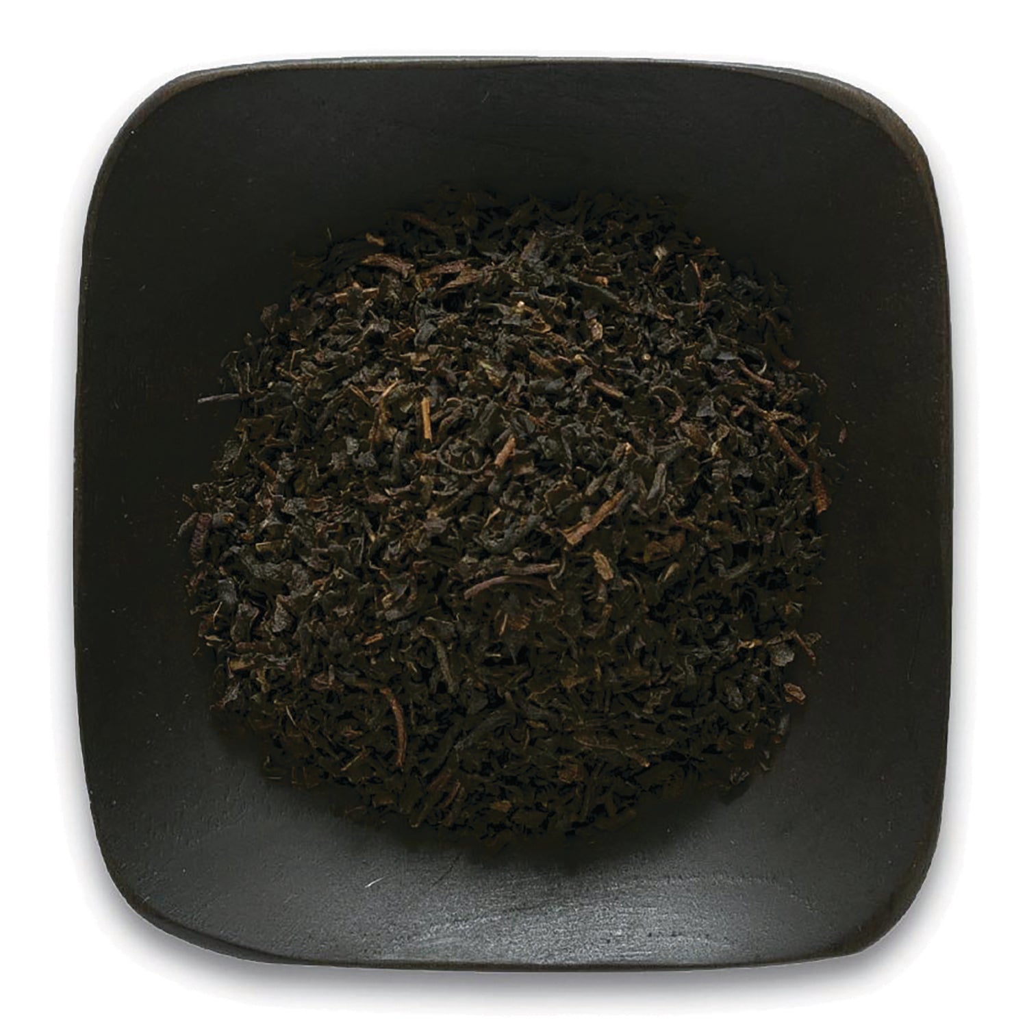 FNP080 | Loose black tea leaves piled in a square black dish