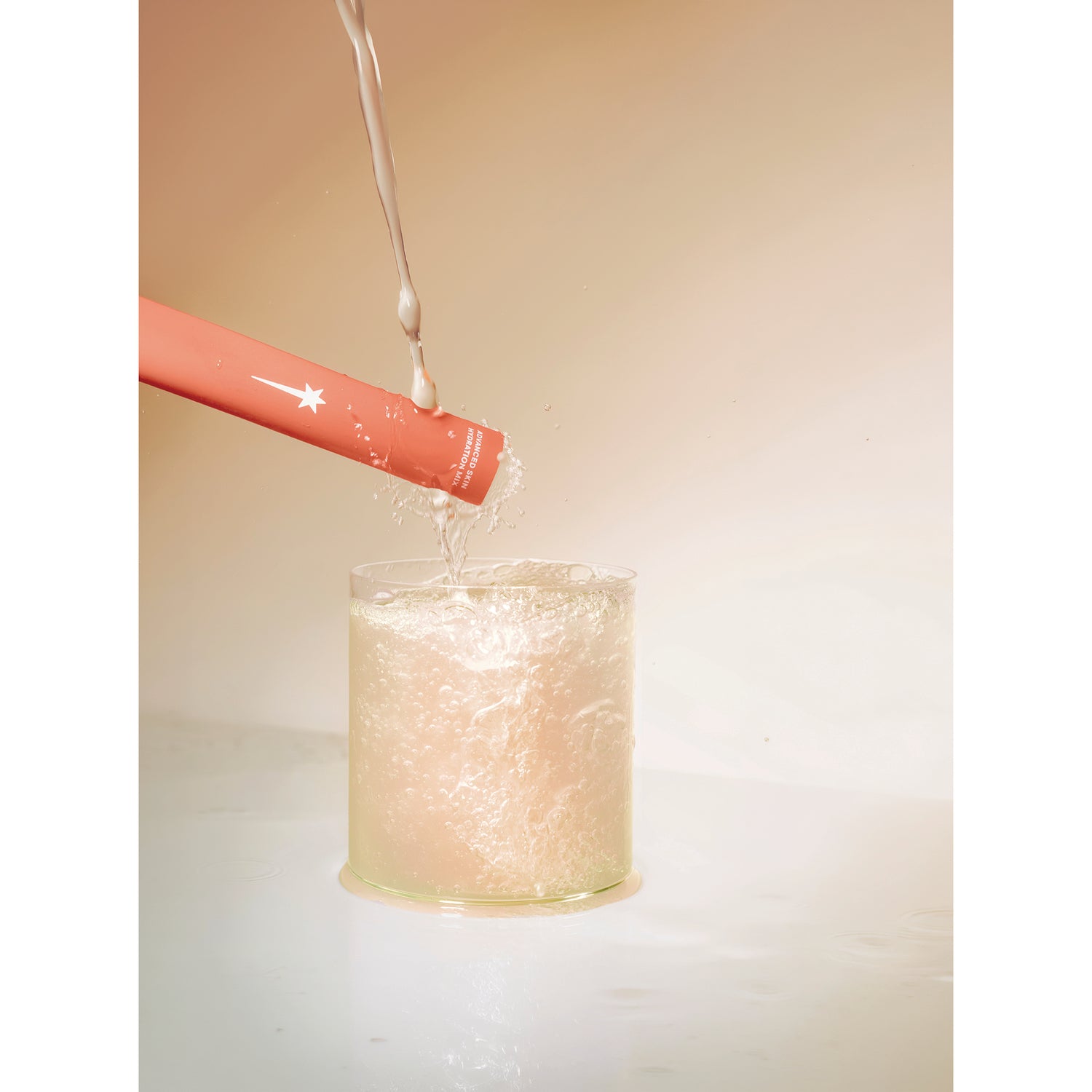 KTO001 | Red cosmetic wand stirring a foaming liquid in a clear glass