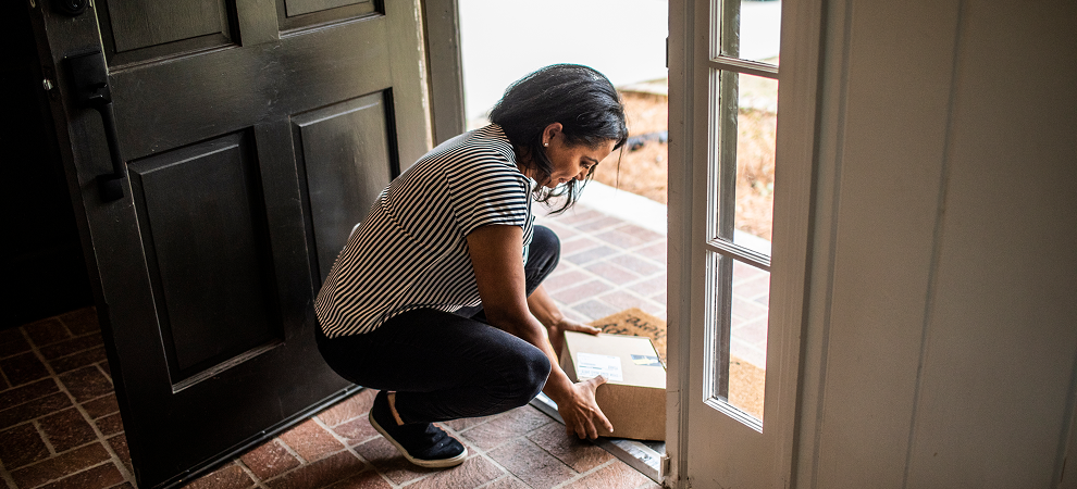 Woman unboxing a package on a doorstep