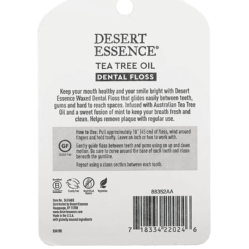 DESERT ESSENCE tea tree oil dental floss back packaging showing usage instructions, barcode, and certification icons - Thumbnail