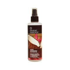 DESERT ESSENCE coconut hair defrizzer & heat protector spray bottle on white background