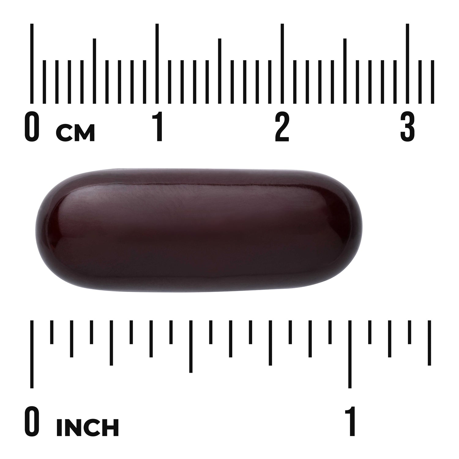 SW882 | Dark softgel capsule shown with centimeter and inch rulers, about 1 inch long