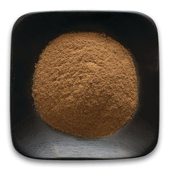 FNP153 | top-down view of fine brown powder mounded in a square black wooden dish