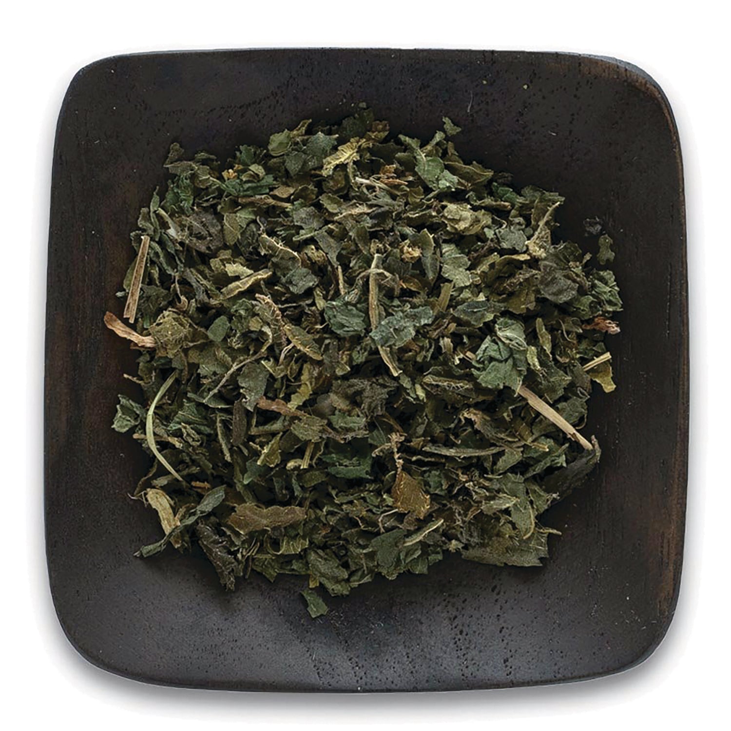 FNP018 | loose dried green herb leaves on a dark square wooden dish