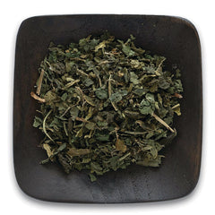FNP018 | loose dried green herb leaves on a dark square wooden dish