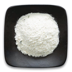 FNP077 | pile of white powder on a black square plate