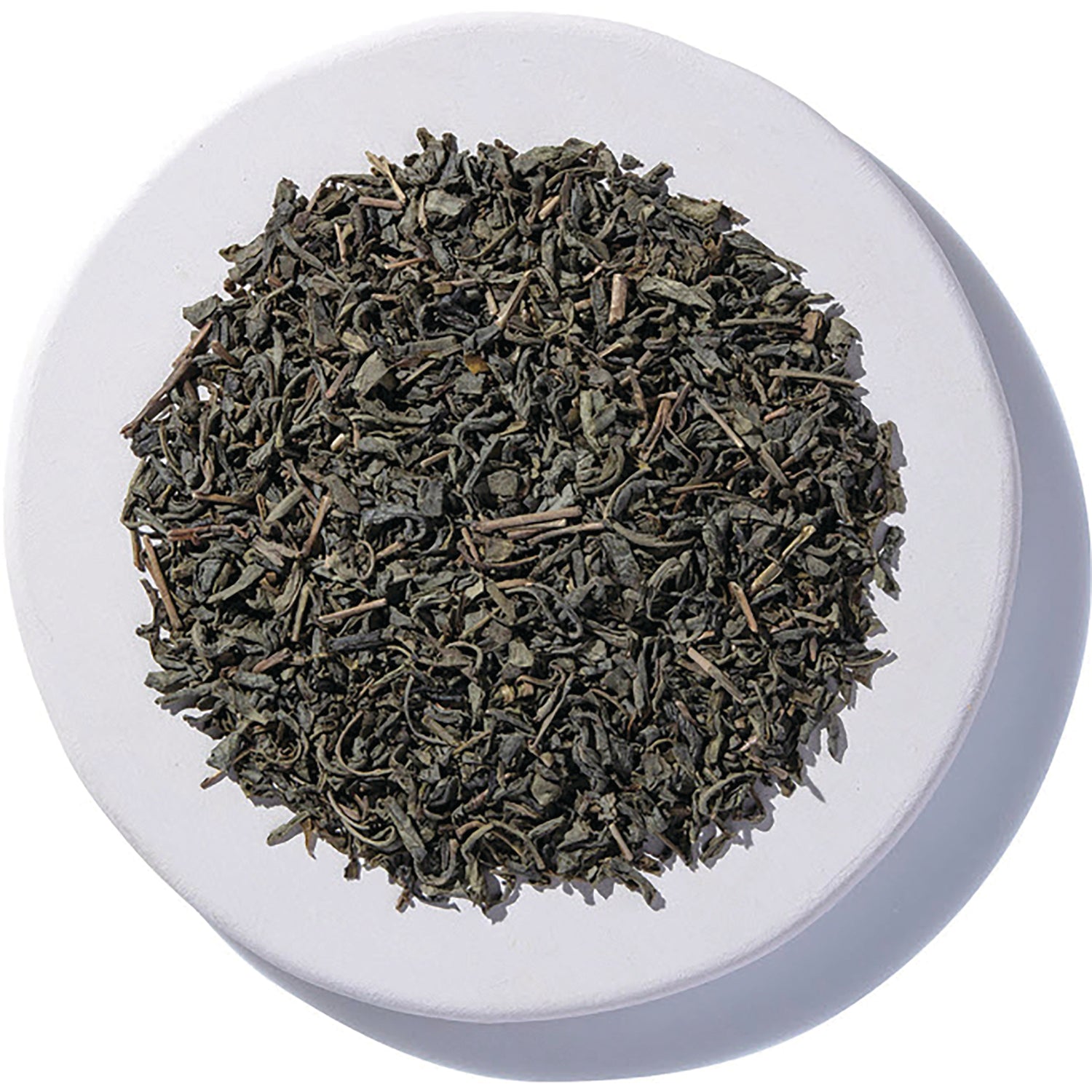 STB028 | Loose leaf green tea on a white dish, top view