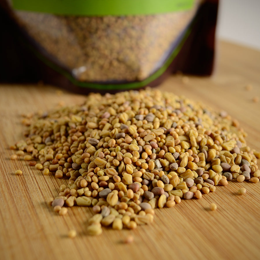 NWF1210 | pile of yellow and brown seeds spilled on wooden board with pouch in background - Thumbnail