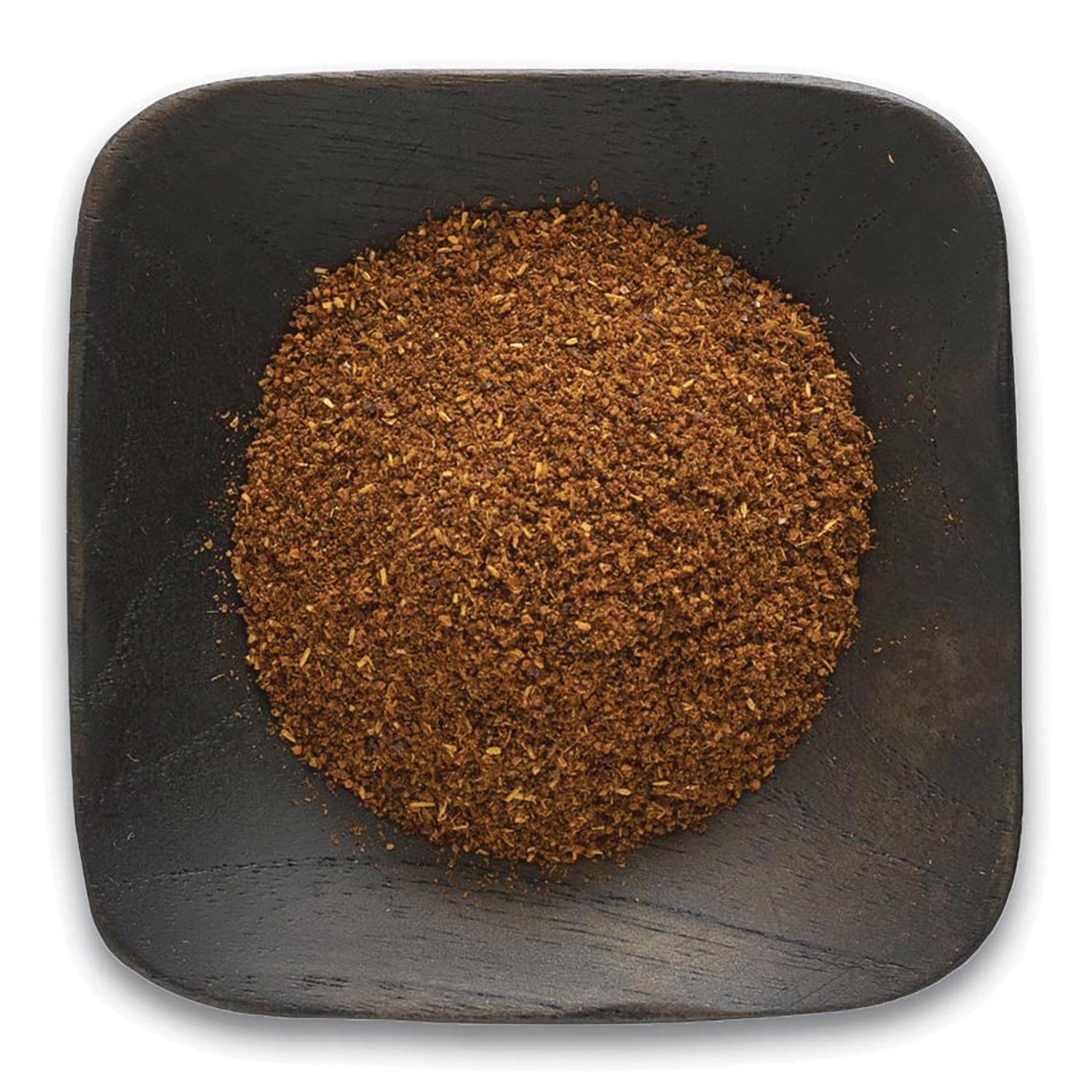 FNP033 | ground brown spice piled on a square dark wooden dish