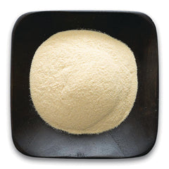 FNP056 | Pale yellow powder mound in a black square dish, top-down product view