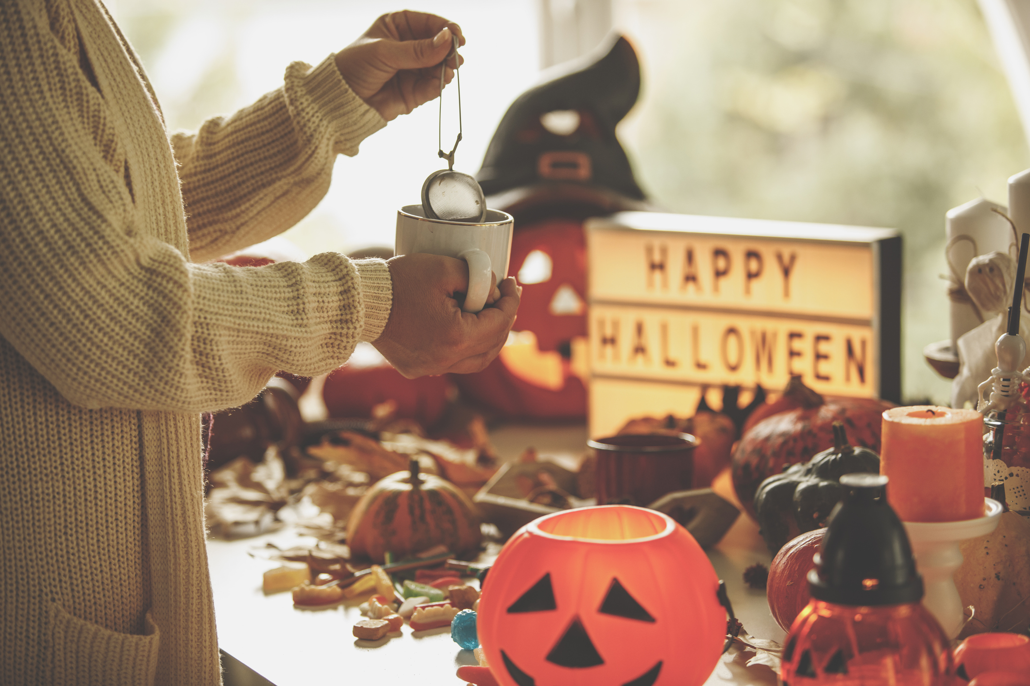 person in sweater during halloween with tea rich in vitamin c