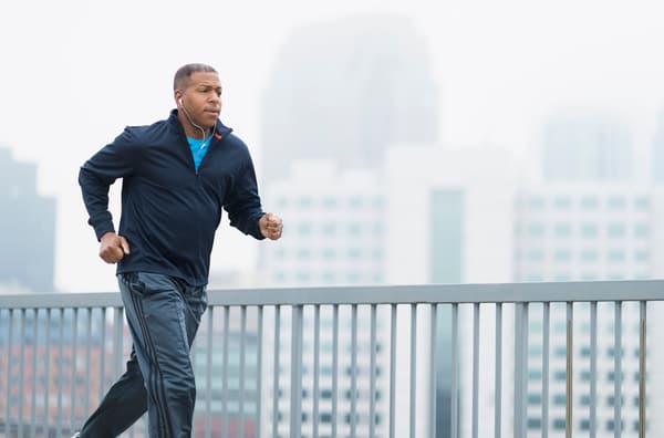 a man jogging on a bridge